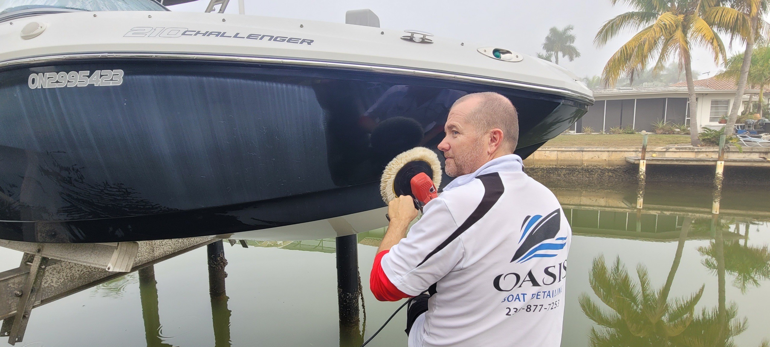 Mobile boat detailing service in action at Naples marina showing professional on-site cleaning and maintenance